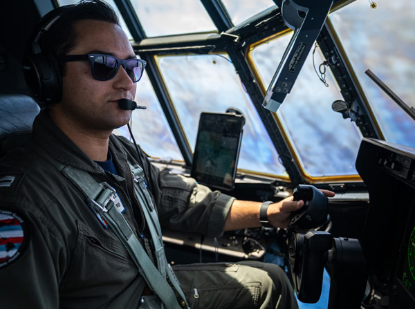 Coast Guard Lt. Camden Cecchini, a pilot assigned to Coast Guard Air Station Barbers Point in Kapolei, Hawaii, mans the controls of a Barbers Point HC-130 Hercules airplane during a training flight offshore Oahu April 24, 2025.